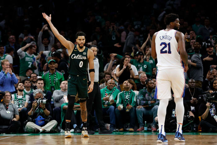 Boston Celtics forward Jayson Tatum (0) acknowledges the crowd as Philadelphia 76ers center Joel Embiid (21) looks away during the fourth quarter at TD Garden.